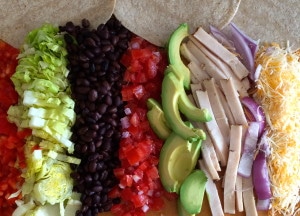 Chicken Tacos, lettuce, black beans, tomato, avocado, red onion, chicken.