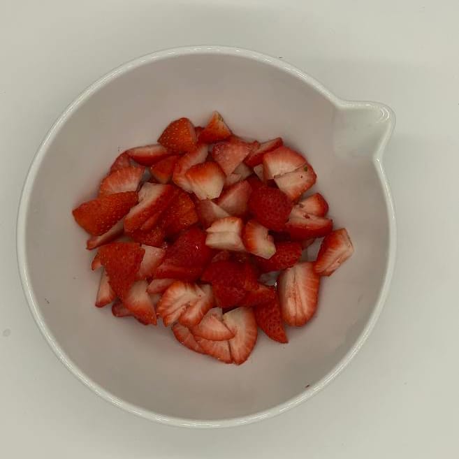 Kiwi Papaya Fruit Salad- diced strawberries in a bowl